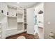 Walk in closet with white shelving and cabinetry, with access to the bathroom at 19191 Pease Pl, Lutz, FL 33558