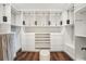 Walk-in closet with custom shelving, drawers, and an ottoman, providing ample storage at 19191 Pease Pl, Lutz, FL 33558