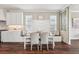 Cozy dining nook with bench seating and a view of the kitchen and brick backsplash at 19191 Pease Pl, Lutz, FL 33558