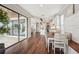 Open-concept dining area with hardwood floors connecting the kitchen, living room, and sliding glass door at 19191 Pease Pl, Lutz, FL 33558