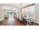 Elegant dining room with a chandelier, hardwood floors, and direct access to the living area at 19191 Pease Pl, Lutz, FL 33558