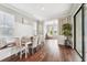 A dining room features a built-in bench seat, seating for six, wood floors, and natural light at 19191 Pease Pl, Lutz, FL 33558