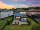 Aerial view of the blue home exterior, back patio, and spacious backyard at 19191 Pease Pl, Lutz, FL 33558