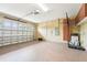 Well-lit garage with epoxy flooring, a basketball hoop, and ample storage cabinets at 19191 Pease Pl, Lutz, FL 33558