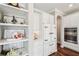 A charming kitchen showcases a retro-style refrigerator, stainless steel appliances, and open shelving at 19191 Pease Pl, Lutz, FL 33558