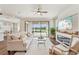 Bright living room with a fireplace, ceiling fan, hardwood floors, and sliding doors to the patio at 19191 Pease Pl, Lutz, FL 33558