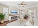 Inviting living room with a ceiling fan, fireplace, and hardwood floors flowing into the dining area at 19191 Pease Pl, Lutz, FL 33558