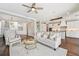 Spacious open-concept living room with hardwood floors, flowing into a bright kitchen and dining area at 19191 Pease Pl, Lutz, FL 33558