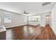 Spacious living room with wood floors and a partial wall at 19191 Pease Pl, Lutz, FL 33558