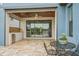 Patio featuring outdoor kitchen and lake views with travertine floors and ceiling fan at 19191 Pease Pl, Lutz, FL 33558