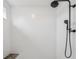 Close up of modern shower featuring white subway tile and a black shower head at 19191 Pease Pl, Lutz, FL 33558