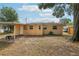 Cozy backyard showcasing the rear exterior of the home with a carport at 2044 Temple Ter, Clearwater, FL 33764