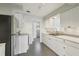 Clean kitchen with white cabinets, stainless appliances, and track lighting at 2044 Temple Ter, Clearwater, FL 33764