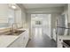 Modern kitchen features ample counter space, stainless steel sink, and access to the living room at 2044 Temple Ter, Clearwater, FL 33764