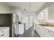 Bright kitchen featuring white cabinets, stainless steel appliances, and a large window at 2044 Temple Ter, Clearwater, FL 33764