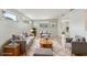Staged living room with neutral colors, comfortable seating, and natural light at 2044 Temple Ter, Clearwater, FL 33764