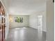 Bright living room with polished floors and a large front window at 2044 Temple Ter, Clearwater, FL 33764
