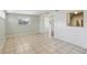 Sunlit living room featuring tile floors, fresh paint, and large windows at 2044 Temple Ter, Clearwater, FL 33764