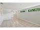 Bright and airy living room featuring tile floors, fresh paint, and natural light at 2044 Temple Ter, Clearwater, FL 33764