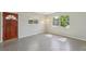 Sunlit living room featuring sleek polished floors and a light fixture at 2044 Temple Ter, Clearwater, FL 33764