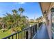 Community balcony showcasing lush tropical landscaping and a vibrant green lawn view at 216 36Th N Ave # 202B, St Petersburg, FL 33704