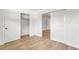 Bright bedroom showcasing wood-style tile flooring, complemented by a closet with sliding doors and a doorway at 216 36Th N Ave # 202B, St Petersburg, FL 33704
