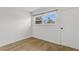 Bright bedroom featuring wood-style tile flooring, a window with a view, and a minimalist aesthetic at 216 36Th N Ave # 202B, St Petersburg, FL 33704