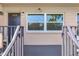 Condo entrance with fresh paint, modern lighting, and a bright window that offers views to the outside at 216 36Th N Ave # 202B, St Petersburg, FL 33704