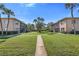 Beautifully maintained condo complex with central lawn, mature palms, and convenient exterior stair access at 216 36Th N Ave # 202B, St Petersburg, FL 33704