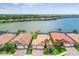Waterfront homes with private screened-in patios overlooking the lake, showcasing community living at 222 Toscavilla Blvd, Nokomis, FL 34275