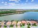 Expansive lake view surrounded by residences and lush landscaping showcasing community living and serene waterfront homes at 222 Toscavilla Blvd, Nokomis, FL 34275