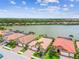 Waterfront homes with screened-in patios and backyard views of the lake, surrounded by lush greenery at 222 Toscavilla Blvd, Nokomis, FL 34275