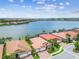 Waterfront homes with lush landscaping and screened-in patios offering serene lake views and community living at 222 Toscavilla Blvd, Nokomis, FL 34275