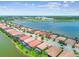 Stunning aerial view of waterfront homes with pools and lush landscaping in a vibrant community at 222 Toscavilla Blvd, Nokomis, FL 34275