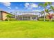 Well-manicured backyard featuring a large screened lanai and lush greenery, ideal for relaxing and entertaining at 222 Toscavilla Blvd, Nokomis, FL 34275