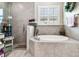 Spa-like bathroom with a soaking tub, a walk-in shower, and natural light, designed for ultimate relaxation and comfort at 222 Toscavilla Blvd, Nokomis, FL 34275