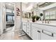 Bright bathroom featuring a double vanity, and an open view of the main bedroom, creating a seamless and luxurious space at 222 Toscavilla Blvd, Nokomis, FL 34275