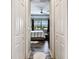Bedroom with wood floor, ceiling fan, a window, and open closet doors at 222 Toscavilla Blvd, Nokomis, FL 34275