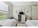 Relaxing bedroom with two beds, entertainment center, and plantation shutters at 222 Toscavilla Blvd, Nokomis, FL 34275