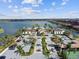 Scenic view of the clubhouse overlooking a lake, showcasing community amenities and parking at 222 Toscavilla Blvd, Nokomis, FL 34275