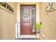 Inviting front entrance adorned with decorative accents and a charming welcome sign at 222 Toscavilla Blvd, Nokomis, FL 34275