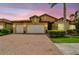Charming home featuring a brick driveway, manicured landscaping, and a spacious three-car garage at 222 Toscavilla Blvd, Nokomis, FL 34275