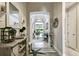 Inviting hallway with views of the living area, featuring elegant decor and ample natural light at 222 Toscavilla Blvd, Nokomis, FL 34275