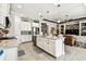 Bright kitchen featuring an island with marble countertops at 222 Toscavilla Blvd, Nokomis, FL 34275