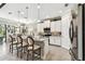 Well-lit kitchen featuring tile flooring, an island with chairs, and stainless steel appliances at 222 Toscavilla Blvd, Nokomis, FL 34275