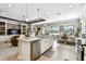 Spacious kitchen with a large island, stainless steel appliances, and views of the dining area at 222 Toscavilla Blvd, Nokomis, FL 34275