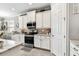 Kitchen featuring stainless steel oven and microwave, white cabinetry, and tile backsplash at 222 Toscavilla Blvd, Nokomis, FL 34275