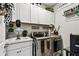 Well-lit laundry room with front-load washer/dryer and white storage cabinets at 222 Toscavilla Blvd, Nokomis, FL 34275