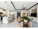 Open concept living area with kitchen, white cabinetry, and island seating at 222 Toscavilla Blvd, Nokomis, FL 34275