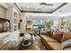 Open-concept living area with large windows offering beautiful backyard views at 222 Toscavilla Blvd, Nokomis, FL 34275